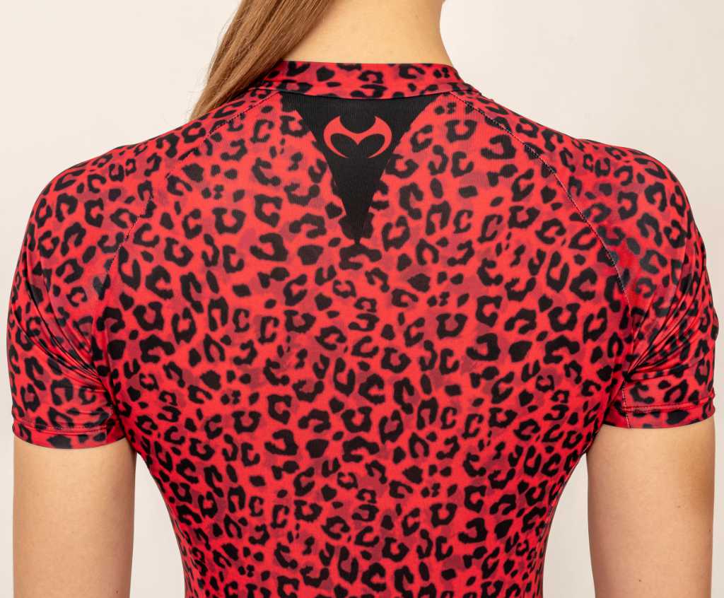 Close up of the Motoko logo in a red leopard running skinsuit.