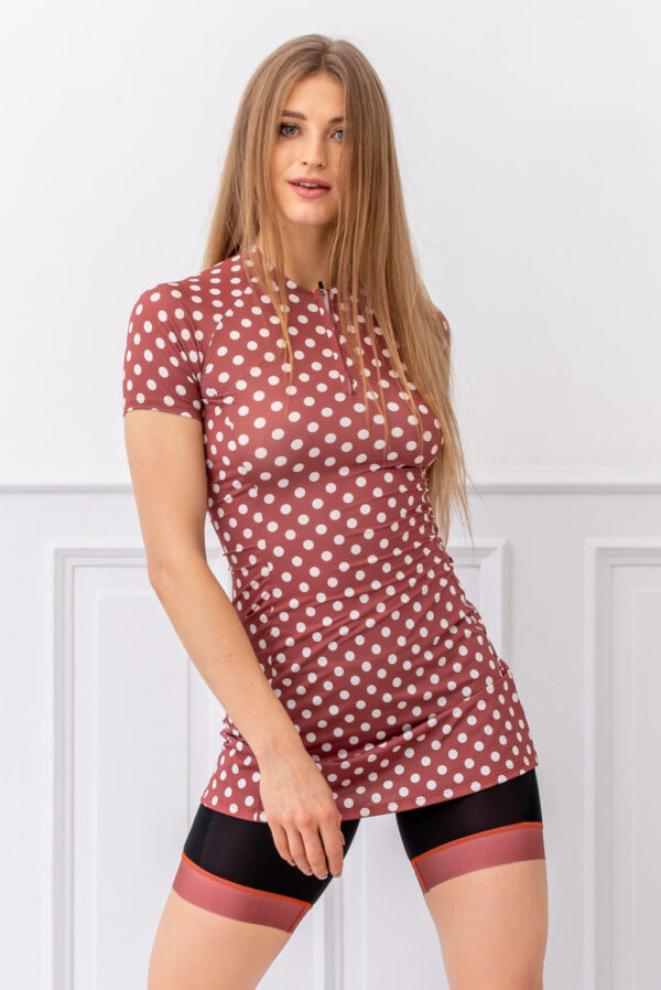 A model in a sporty brown dress with white polka dots, fastened with a zipper.